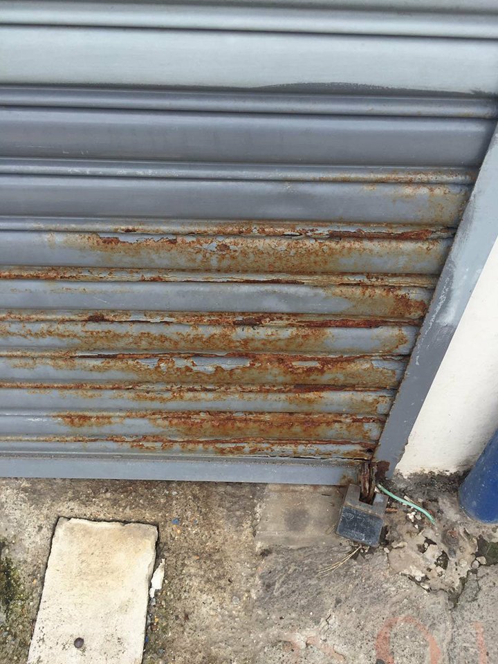 Portón tipo cortina metálica oxidado en Cartago- Reparación